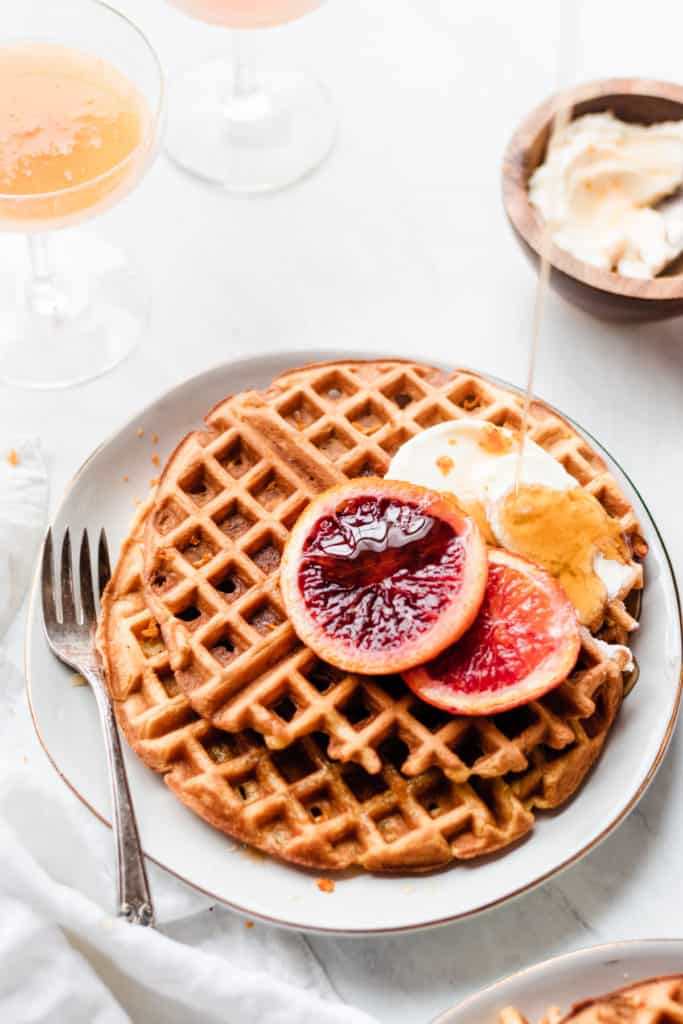 Waffles and blood orange slices on a plate with honey mascarpone