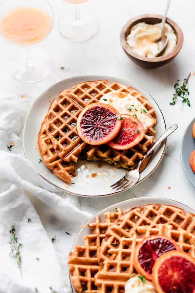 Waffles sliced on a plate with blood orange slices