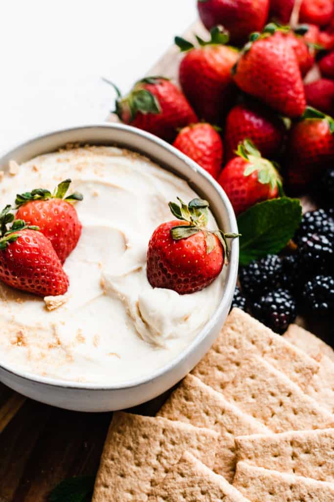 4-Ingredient Cheesecake Dip - Spring and Easter are just around the corner - and this is the perfect treat to celebrate! Bonus - it's easy enough for the kids to help! All you need are 4 simple ingredients - sweetened condensed milk, cream cheese, powdered sugar, and vanilla. Serve with fresh fruit & graham crackers for an epic dessert board the family will love! #cheesecake #dip #glutenfreerecipes #nobakerecipes #bakingwithkids #cheesecakerecipes #bluebowlrecipes | bluebowlrecipes.com 