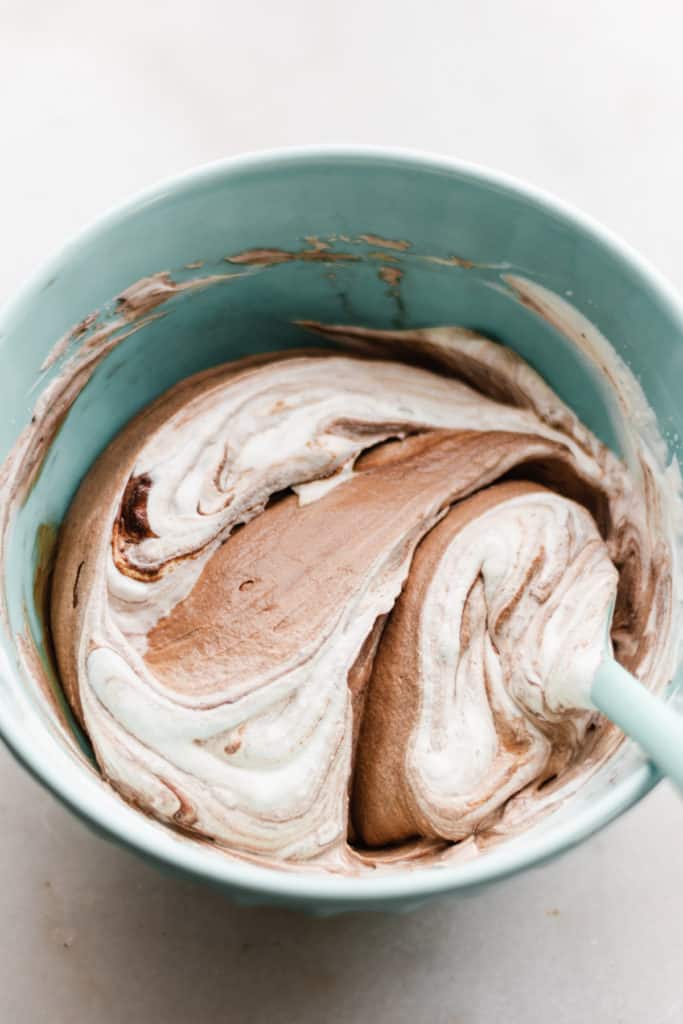 Chocolate and heavy cream mixing together in a bowl