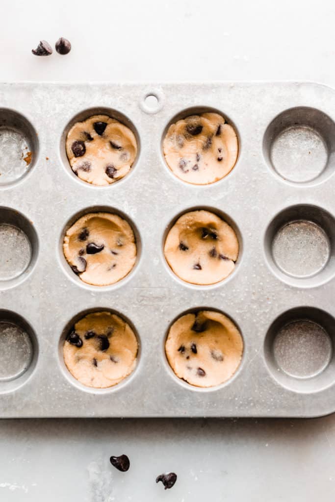 Cookie batter in small muffin tins.