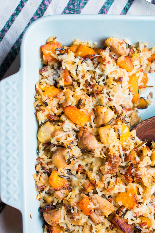 Healthy Chicken Wild Rice Casserole - An easy and wholesome comfort food casserole made with wild rice, chicken, butternut squash, a little parmesan, and cozy spices like thyme and sage. Healthy food meets comfort food in the most delicious way! #butternutsquash #winterrecipes #casserole #comfortfood #healthyrecipes #dinnerrecipes #wildrice #chicken #glutenfree #glutenfreerecipes #bluebowlrecipes | bluebowlrecipes.com