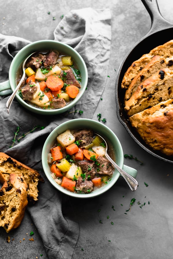 Irish stew in bowls and a loaf of Irish soda bread.