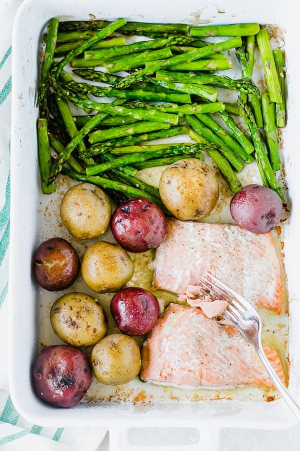 Asparagus, salmon, and potatoes in a pan.