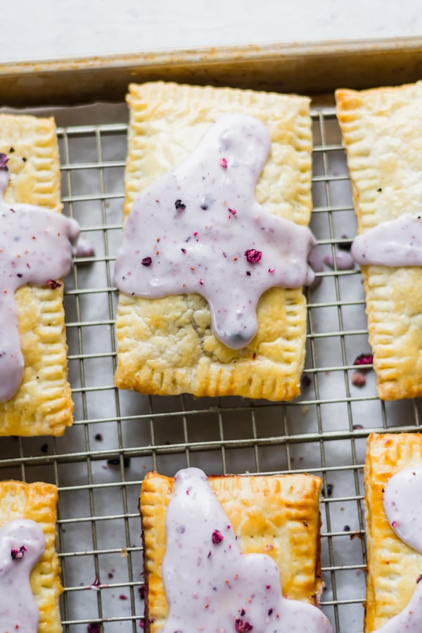 Blueberry poptarts on a cooling rack.