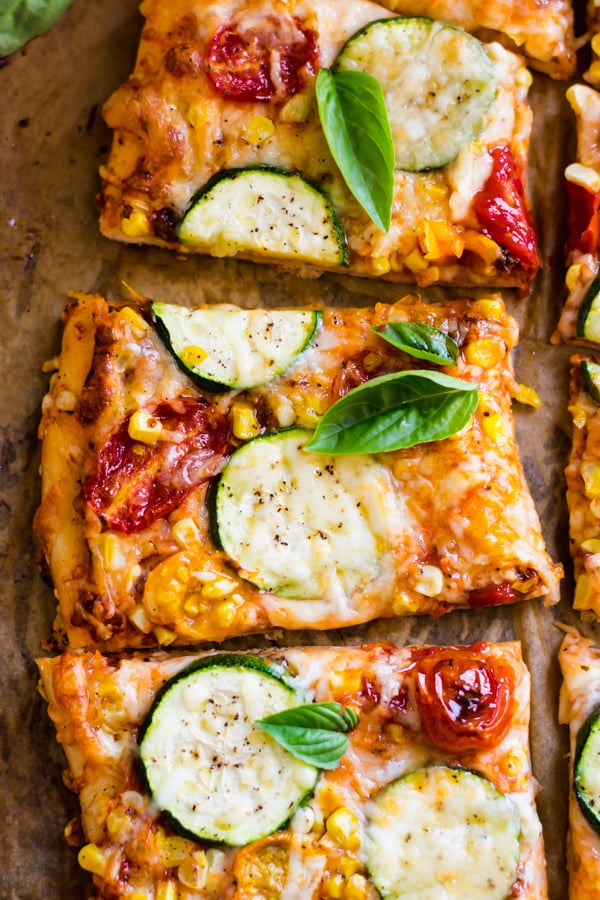 Slices of Roasted Tomato, Corn, and Zucchini Flatbread Pizza.