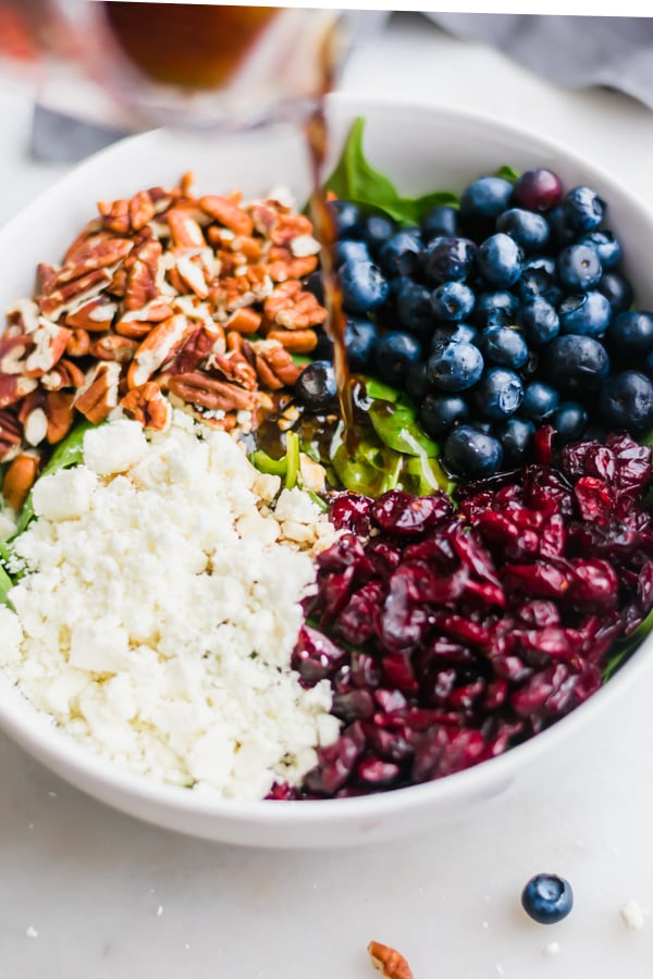 Blueberry spinach salad ingredients in a bowl.
