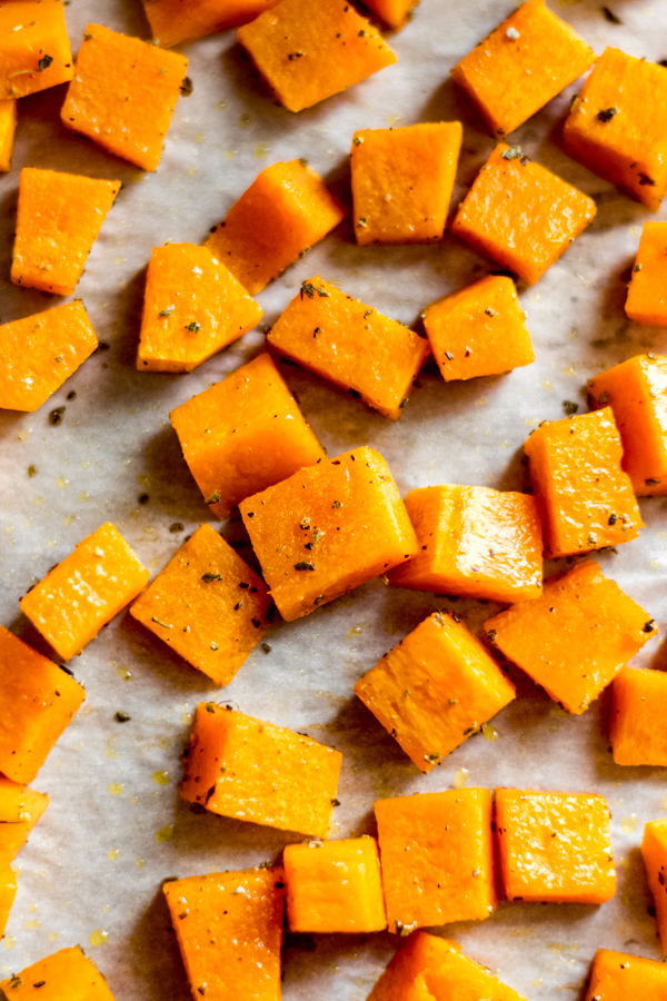 Roasted squash cubes on a tray.