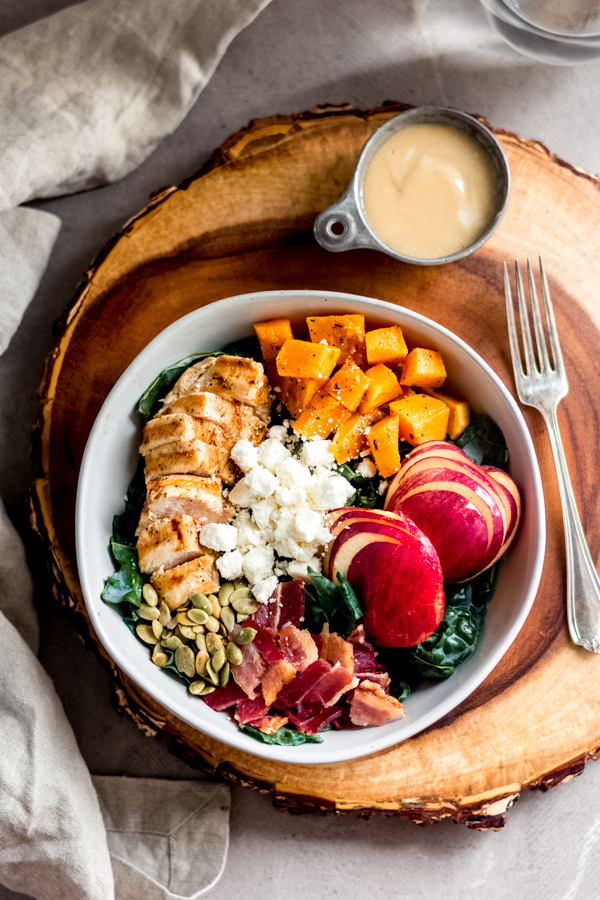Fall harvest salad with maple tahini dressing in a bowl.