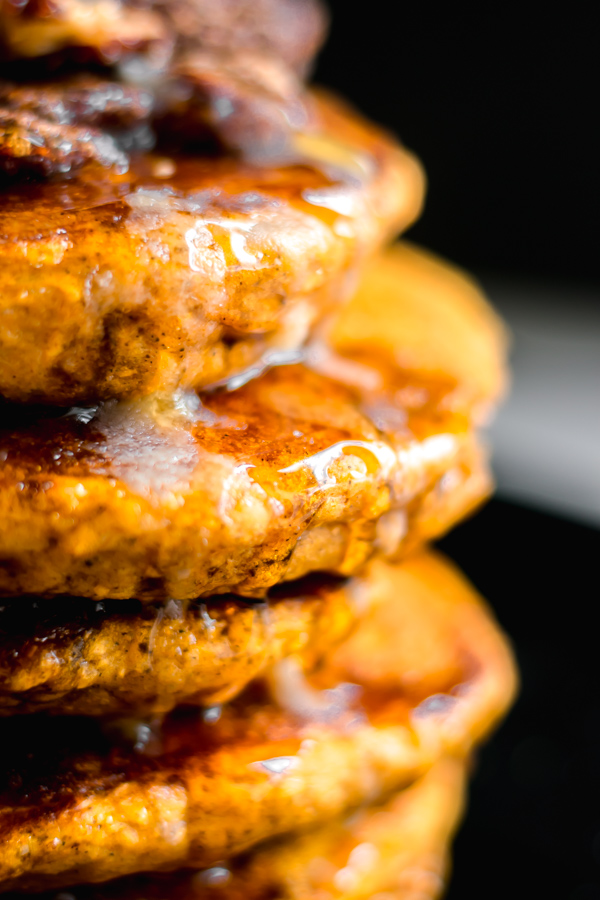 Close-up of fluffy pumpkin pancakes with syrup.