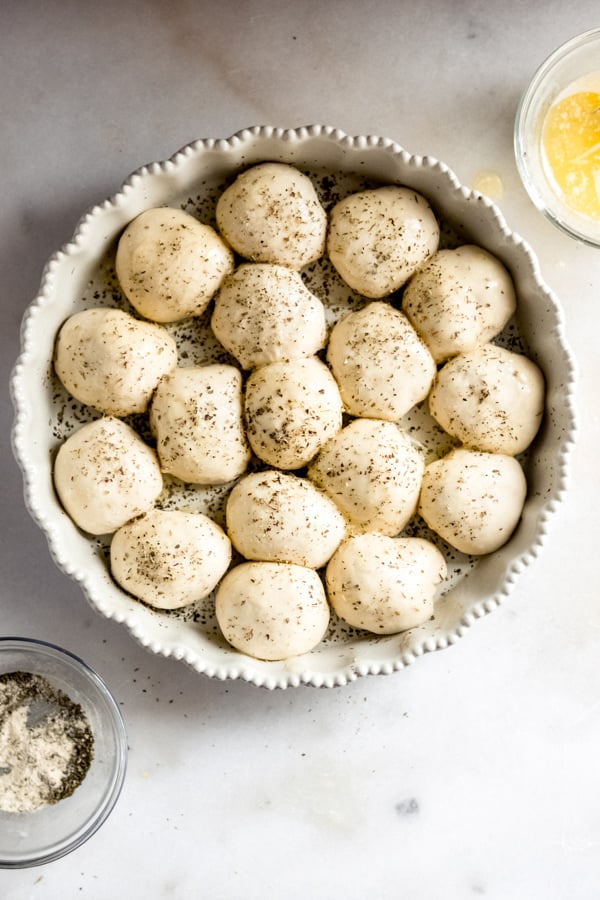 Cheesy garlic herb dough balls in a pan.