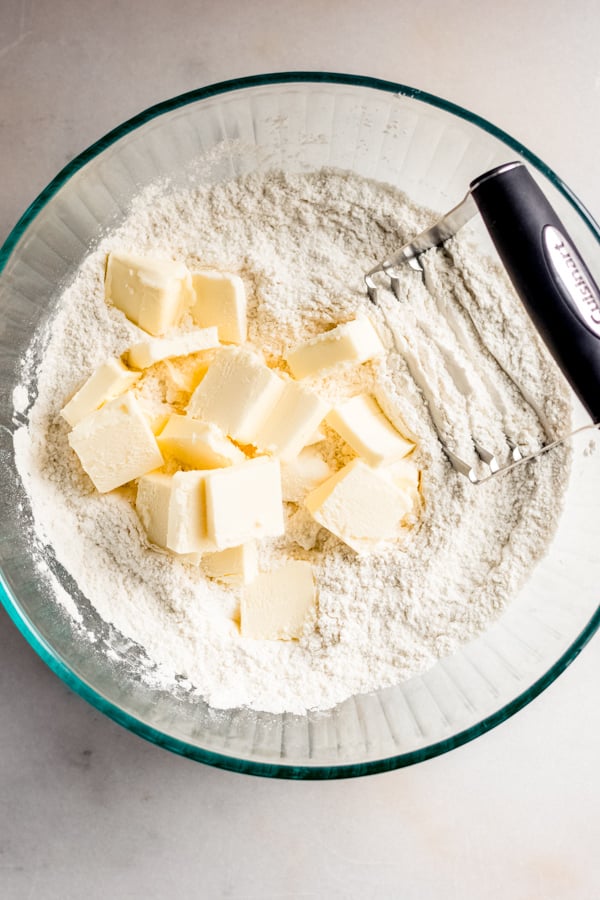 Cubed cold butter in a bowl of flour.