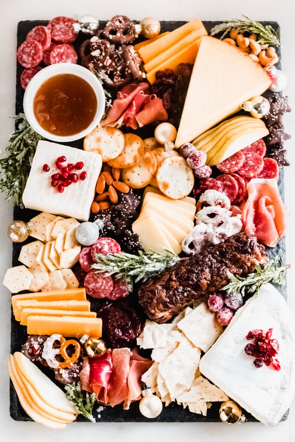 A cheese board full of food.