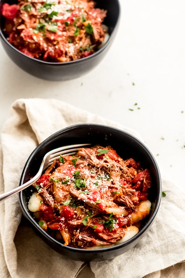 Braised beef with tomatoes and gnocchi in a bowl.