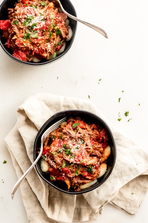 Braised beef with tomatoes and gnocchi in a bowl.