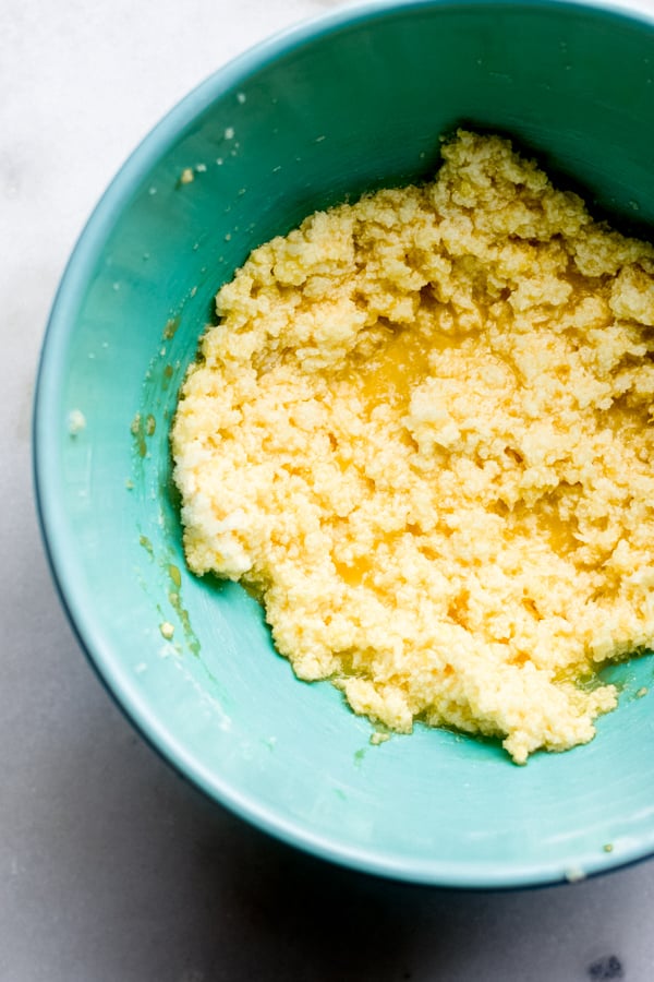 Butter, sugars, and egg mixing in a bowl.