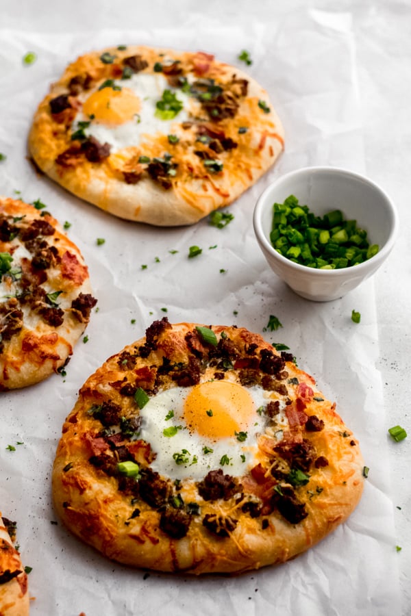 Breakfast pizza on a white surface.