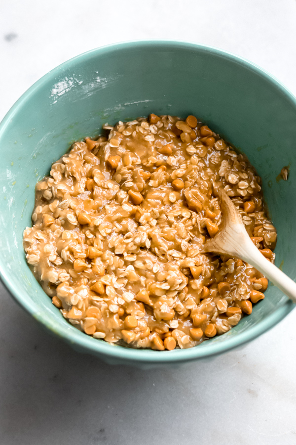 Blondie batter with oats and butterscotch chips mixing in a bowl.