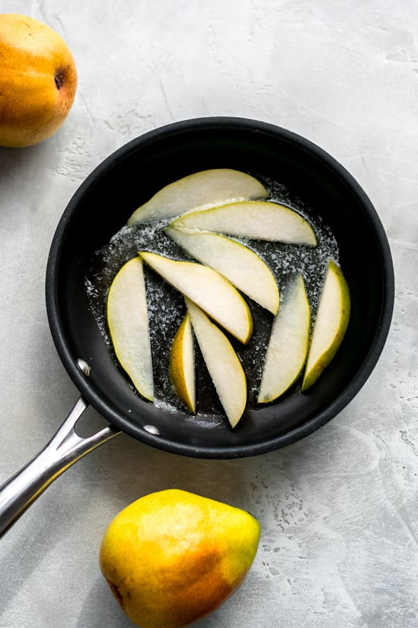 Sliced pears in a pan.