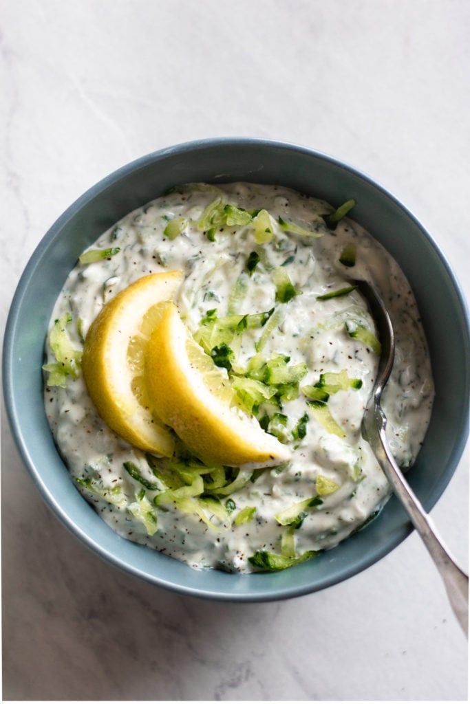 Gyro sauce in a bowl with lemons.