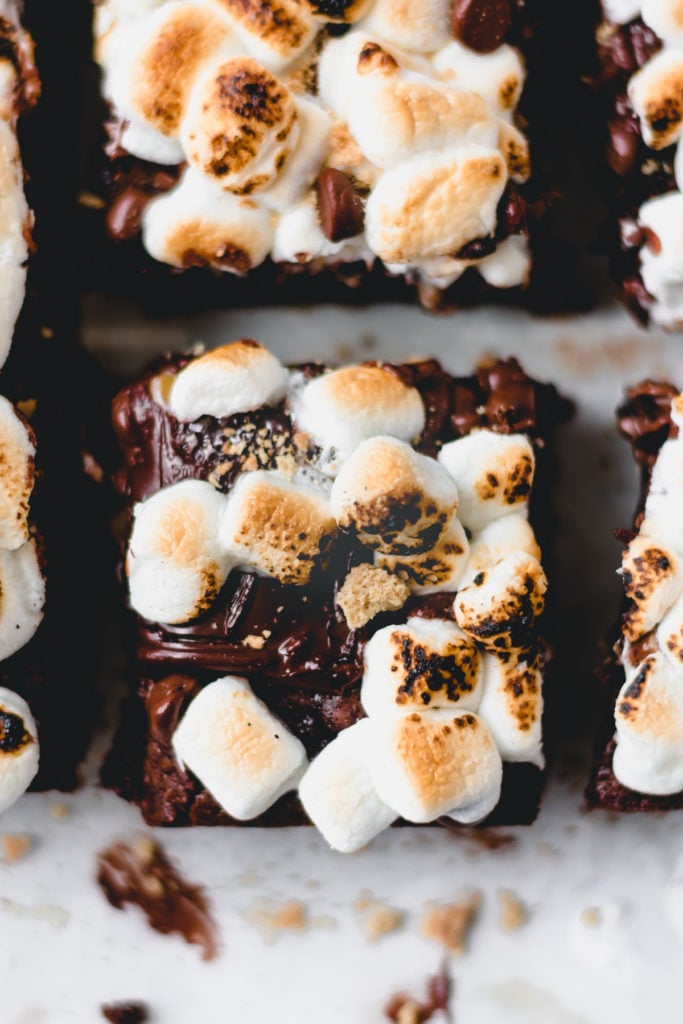A bird's-eye view of a s'mores brownie topped with melty chocolate and gooey toasted marshmallows.