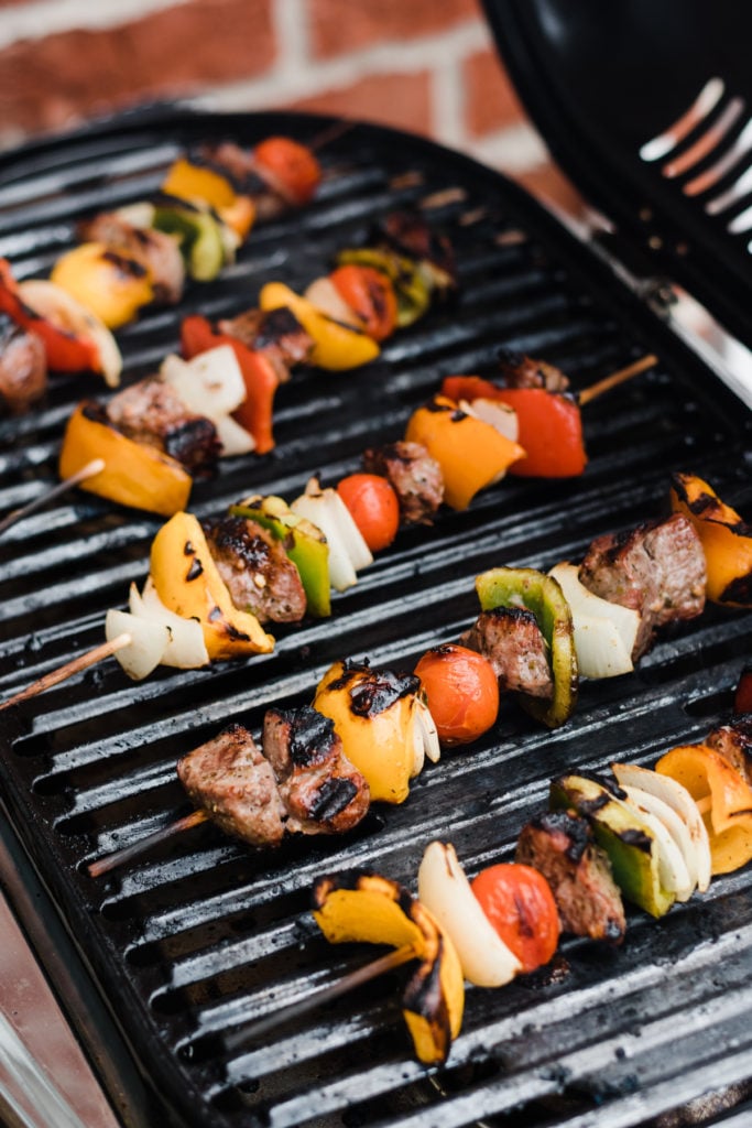 Completed lamb kebabs on a grill.