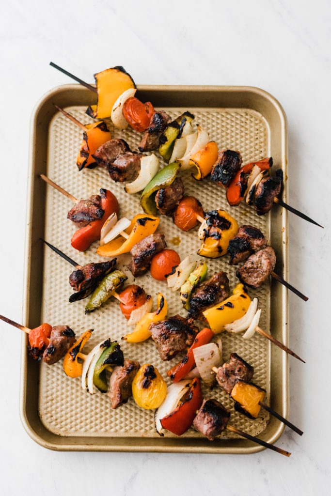 Lamb kebabs on a cooking tray.