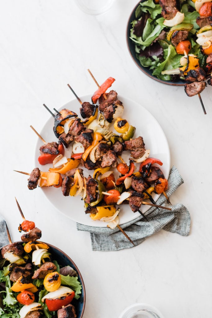 Lamb kebabs on a white plate.