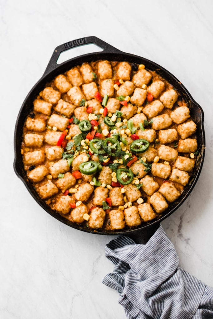 Completed tater tot hot dish in a cast iron skillet.