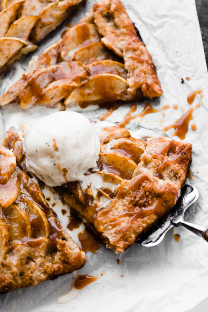 Close-up of a slice of the salted caramel pear galette with a scoop of vanilla ice cream.