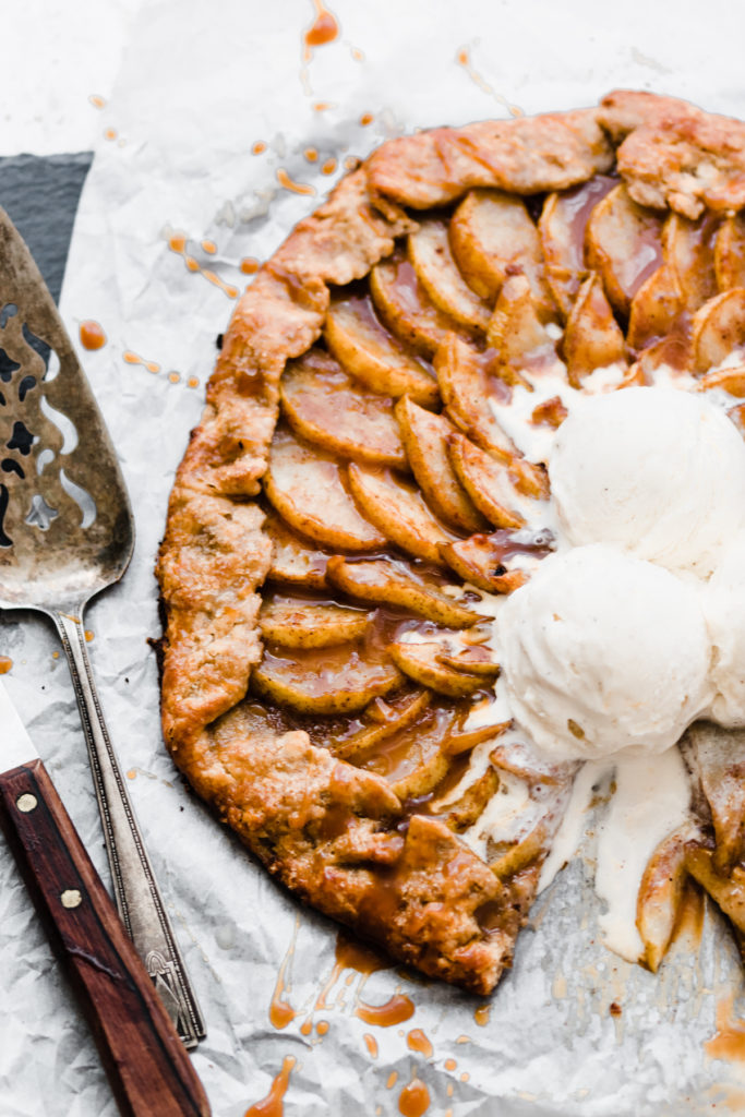 Close-up of a pear galette with scoops of vanilla ice cream.