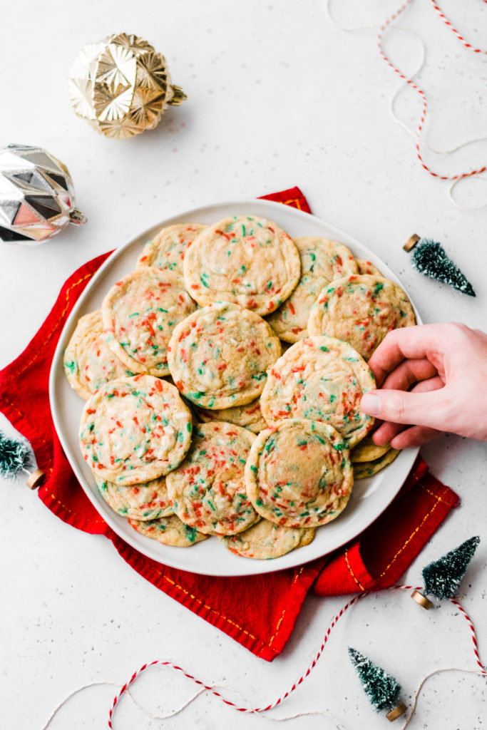 Funfetti Christmas Cookies - Funfetti Christmas Cookies taste just like the funfetti cake mix cookies - without the box mix! These are soft, so easy to make, and loaded with white chocolate chips and sprinkles. Perfectly festive for the holiday season! #christmascookies #christmasrecipes #christmasdesserts #dessertrecipes #cookierecipes #chreistmasbaking #bakingrecipes #easyrecipes #bluebowlrecipes | bluebowlrecipes.com