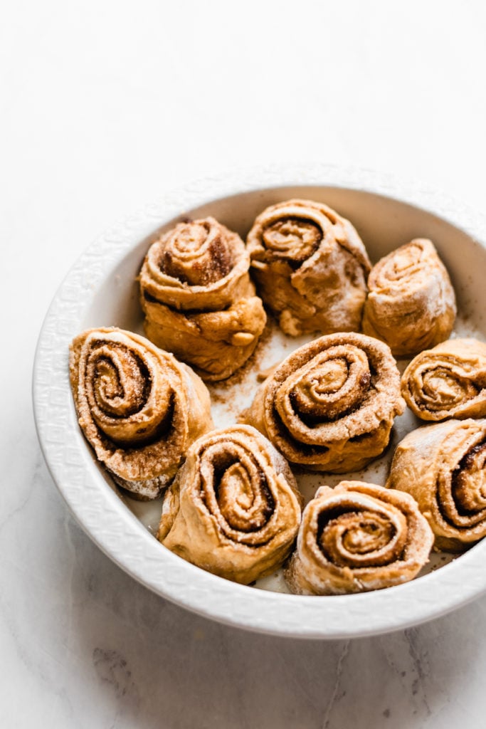 Overnight Gingerbread Cinnamon Rolls - Overnight Gingerbread Cinnamon Rolls are the BEST holiday brunch! They're soft and pillowy and flavored with ginger, cinnamon, and molasses, & filled with butter, brown sugar, cozy spices, and molasses! Top with a classic Cream Cheese Icing, and prepare to forget that any other brunch food exists! #gingerbread #cinnamonrolls #holidaybrunch #christmasbreakfast #christmasbrunch #christmasbaking #frosting #bluebowlrecipes | bluebowlrecipes.com