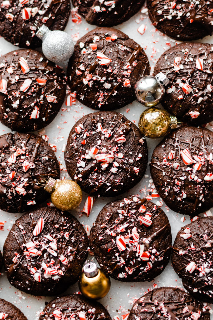 Peppermint mocha cookies with christmas ornaments scattered around.
