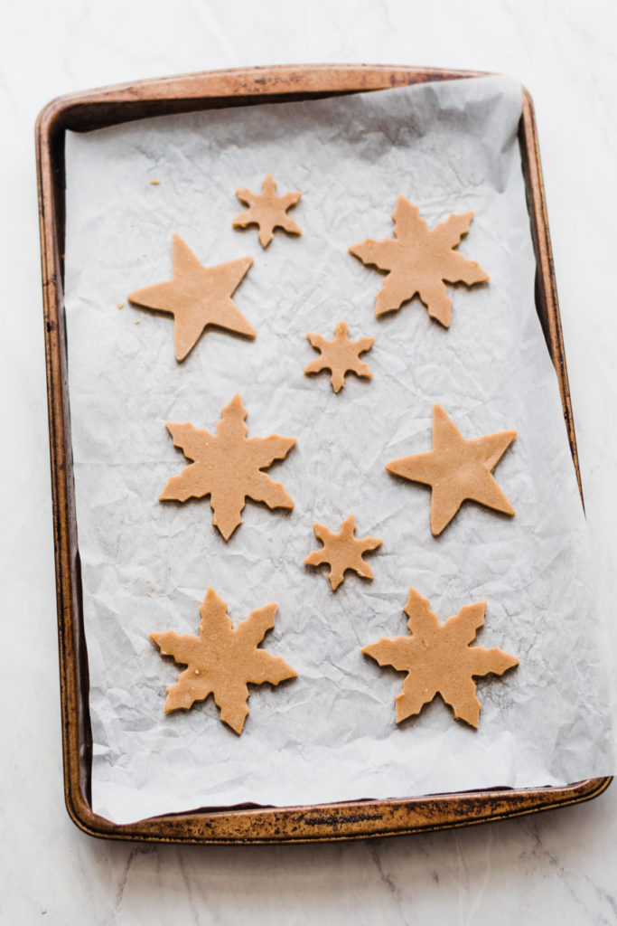 Cinnamon Maple Cutout Cookies - This is my all-time favorite cutout cookie recipe! Adapted from the recipe my mom & grandma used for years. Perfectly soft, lightly spiced with cinnamon & flavored with maple, and they hold their shapes while baking! Decorate by dipping them in white chocolate & adding sprinkles for an easy festive look! #cookierecipes #christmascookies #christmasbaking #easyrecipes #dessertrecipes #holidayrecipes #cinnamon #maple #chocolate #bluebowlrecipes | bluebowlrecipes.com