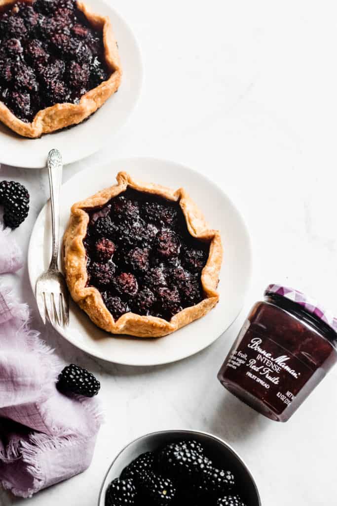 These galettes are made with an ultra flaky whole wheat pie crust and filled with a delicious red fruits spread & a simple blackberry fruit filling. Incredibly delicious, juicy, fresh, and lower in sugar – this is what New Year’s desserts look like, and I am fully on board. #galette #dessertrecipes #easyrecipes #healthyrecipes #healthydesserts #healthybaking #baking #blackberry #healthytreat #smallbatch #dessert #bluebowlrecipes | bluebowlrecipes.com