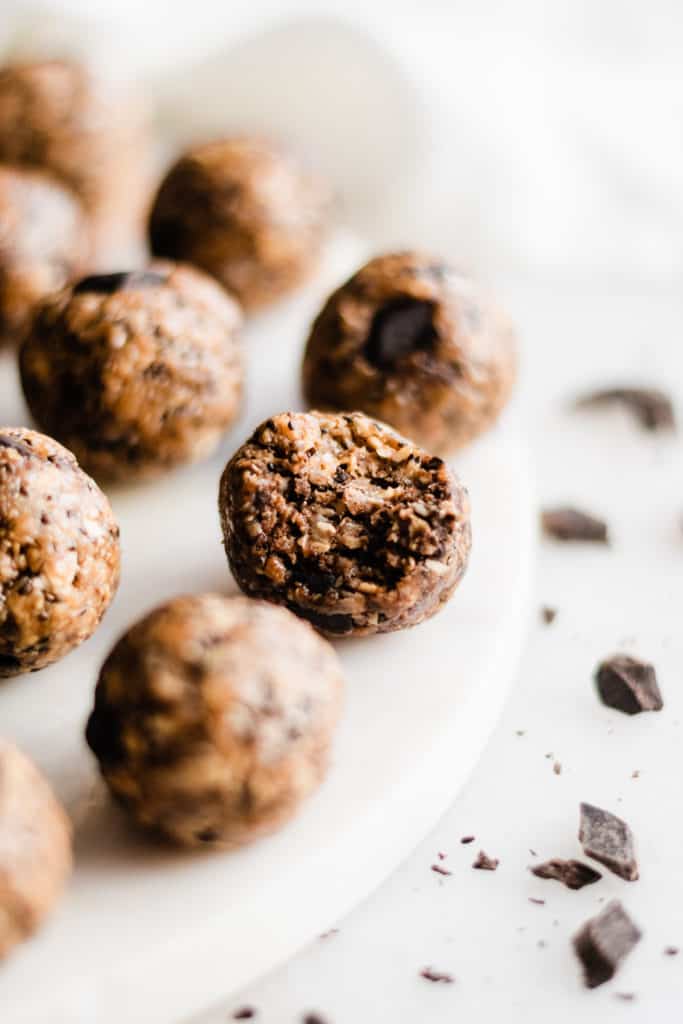 Healthy Cookie Dough Energy Bites - These Energy Bites taste just like little balls of chocolate chip cookie dough - but they're way healthier! Made with real-food ingredients like oats, shredded coconut, chia seeds, honey or maple syrup, any nut butter, and chocolate chips! They're vegan, gluten-free, and oh-so-delicious! #energybites #energyballs #cookiedough #healthyrecipes #glutenfreerecipes #veganrecipes #breakfastrecipes #chocolate #dairyfreerecipes #bluebowlrecipes | bluebowlrecipes.com