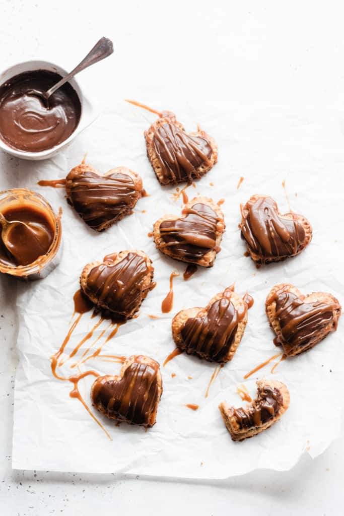 Heart-shaped nutella pop tarts topped with nutella glaze and a drizzle of salted caramel sauce.