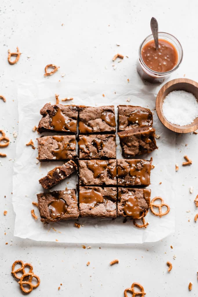 Salted Caramel Pretzel Brownies - Prepare to fall in love with Salted Caramel Pretzel Brownies! Fudgy and rich, these brownies are studded with pools of melty salted caramel sauce and chunks of pretzels. Finish them off with extra caramel sauce and a sprinkle of flaky sea salt for utter dessert perfection! #brownies #caramel #saltedcaramel #caramelsauce #brownierecipes #valentinesdayrecipes #dessert #dessertrecipes #baking #chocolate #valentinesdessert #bluebowlrecipes | bluebowlrecipes.com