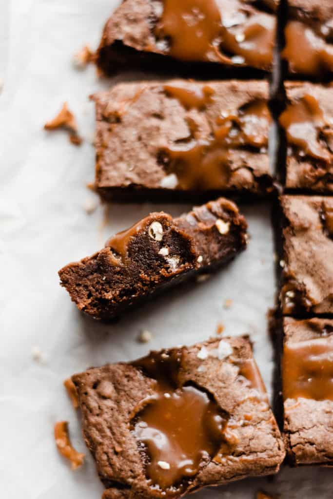 Salted Caramel Pretzel Brownies - Prepare to fall in love with Salted Caramel Pretzel Brownies! Fudgy and rich, these brownies are studded with pools of melty salted caramel sauce and chunks of pretzels. Finish them off with extra caramel sauce and a sprinkle of flaky sea salt for utter dessert perfection! #brownies #caramel #saltedcaramel #caramelsauce #brownierecipes #valentinesdayrecipes #dessert #dessertrecipes #baking #chocolate #valentinesdessert #bluebowlrecipes | bluebowlrecipes.com