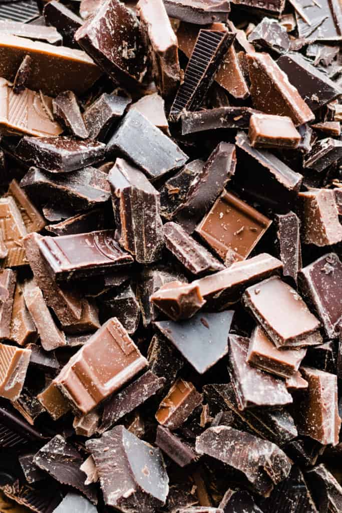 A close-up of three kinds of chopped chocolate.