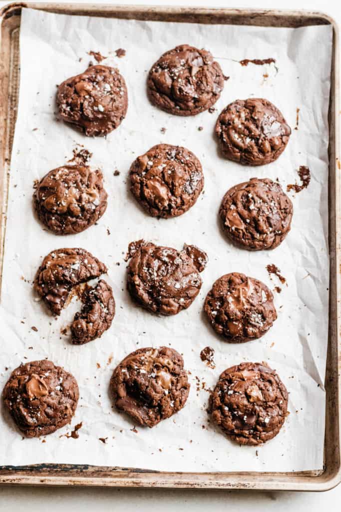Triple chocolate chunk cookies on a baking sheet.