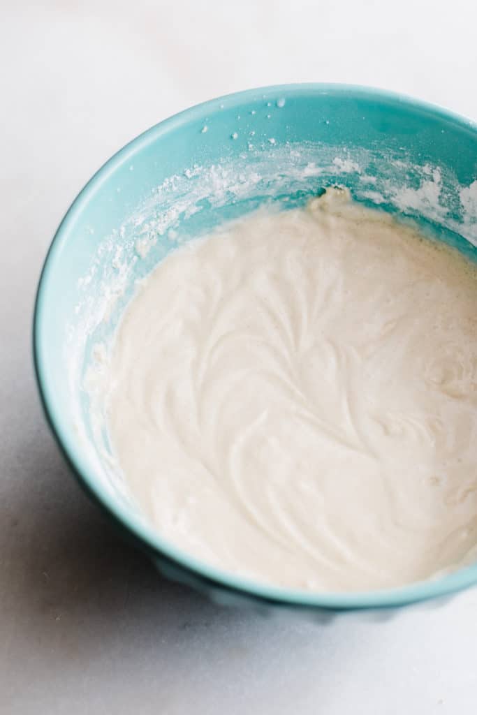 A mixing bowl full of smooth cupcake batter