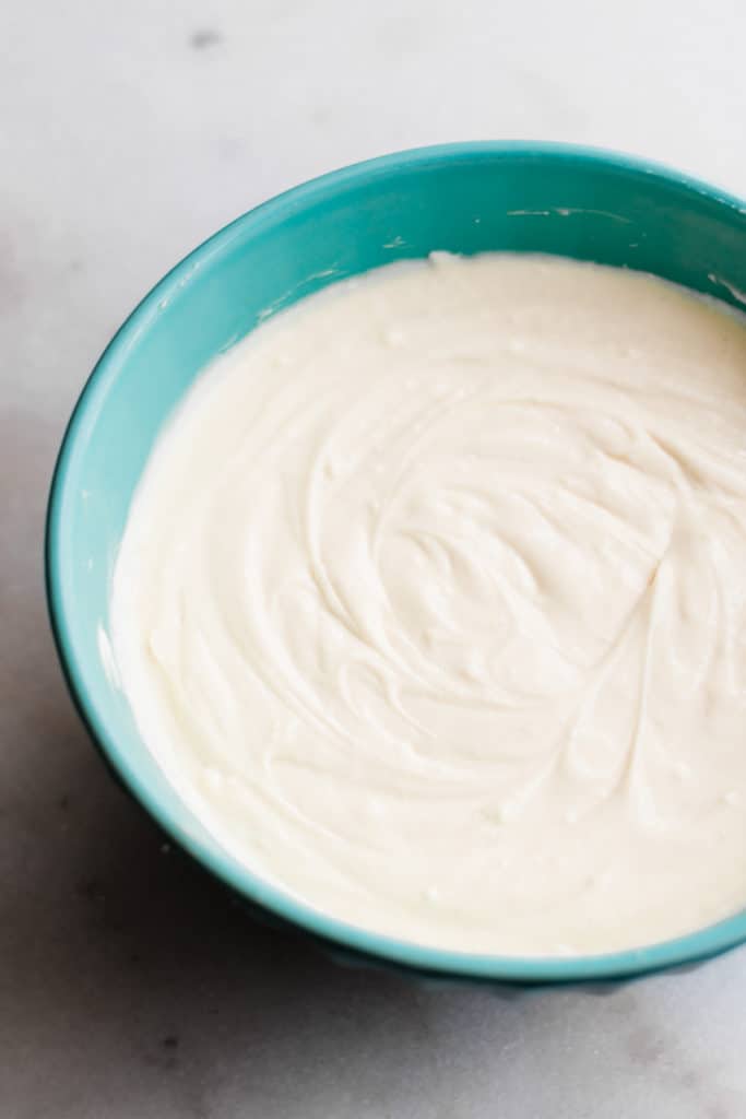 Smooth cheesecake batter in a mixing bowl.