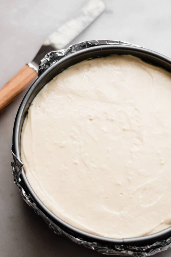 Cheesecake filling spread evenly in pan, unbaked.