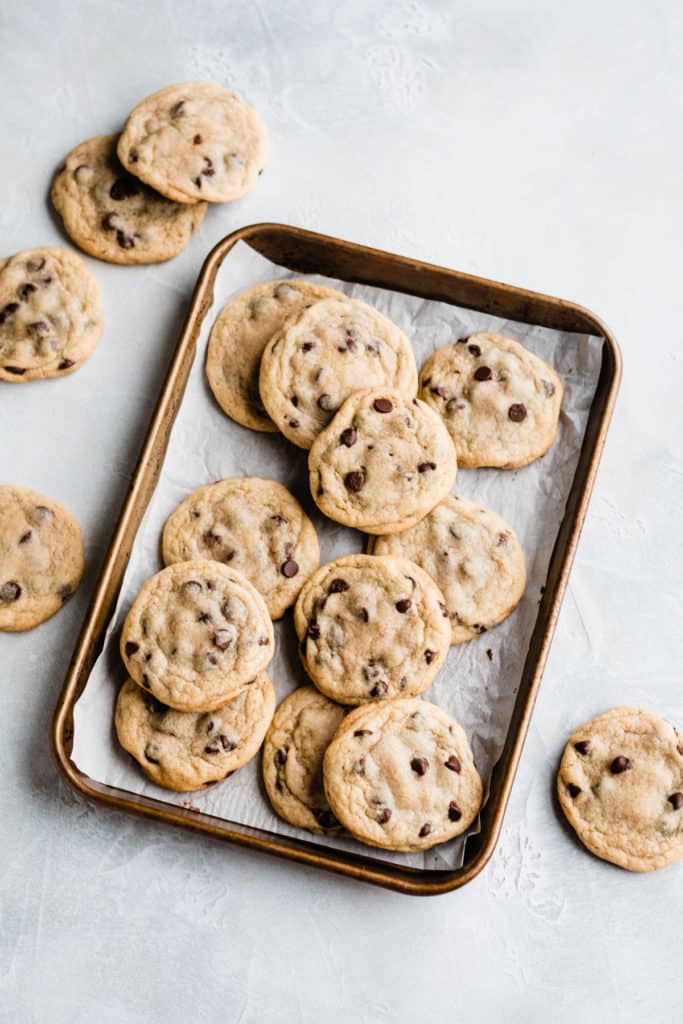 Chocolate Chip Cookies on a small sheet pan on a gray surface