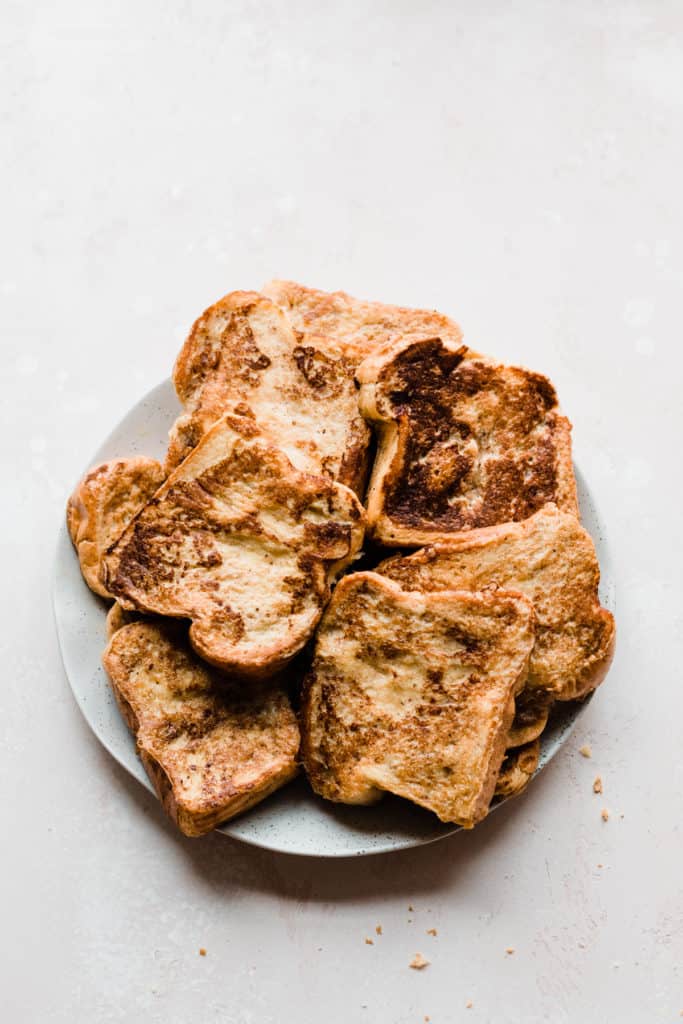 A plate of golden brown french toast slices 