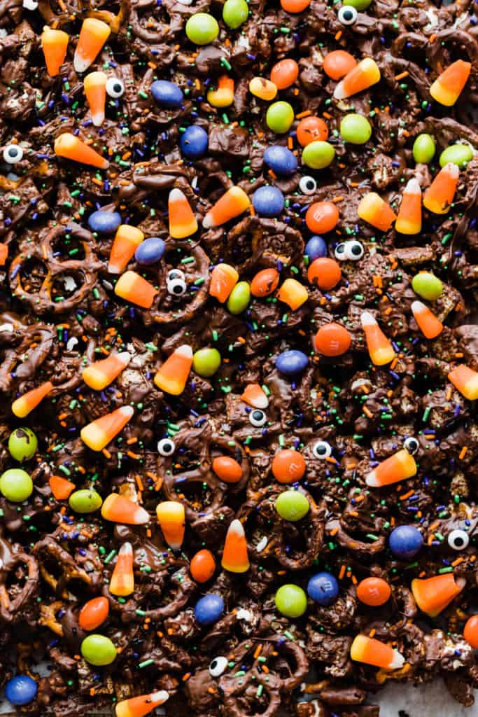 A close-up of the halloween snack mix covered in sprinkles, candy corn, and m&ms