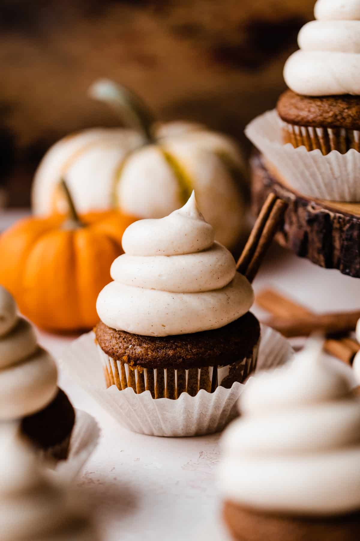 Pumpkin cupcakes frosted with swirls of brown butter cream cheese frosting.