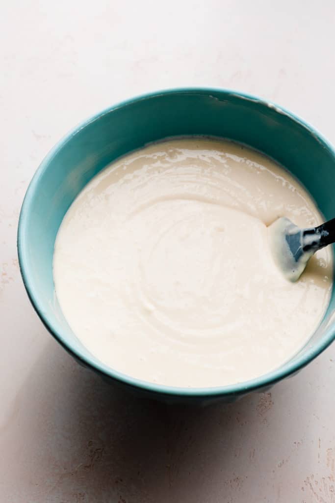 A mixing bowl full of creamy cheesecake batter